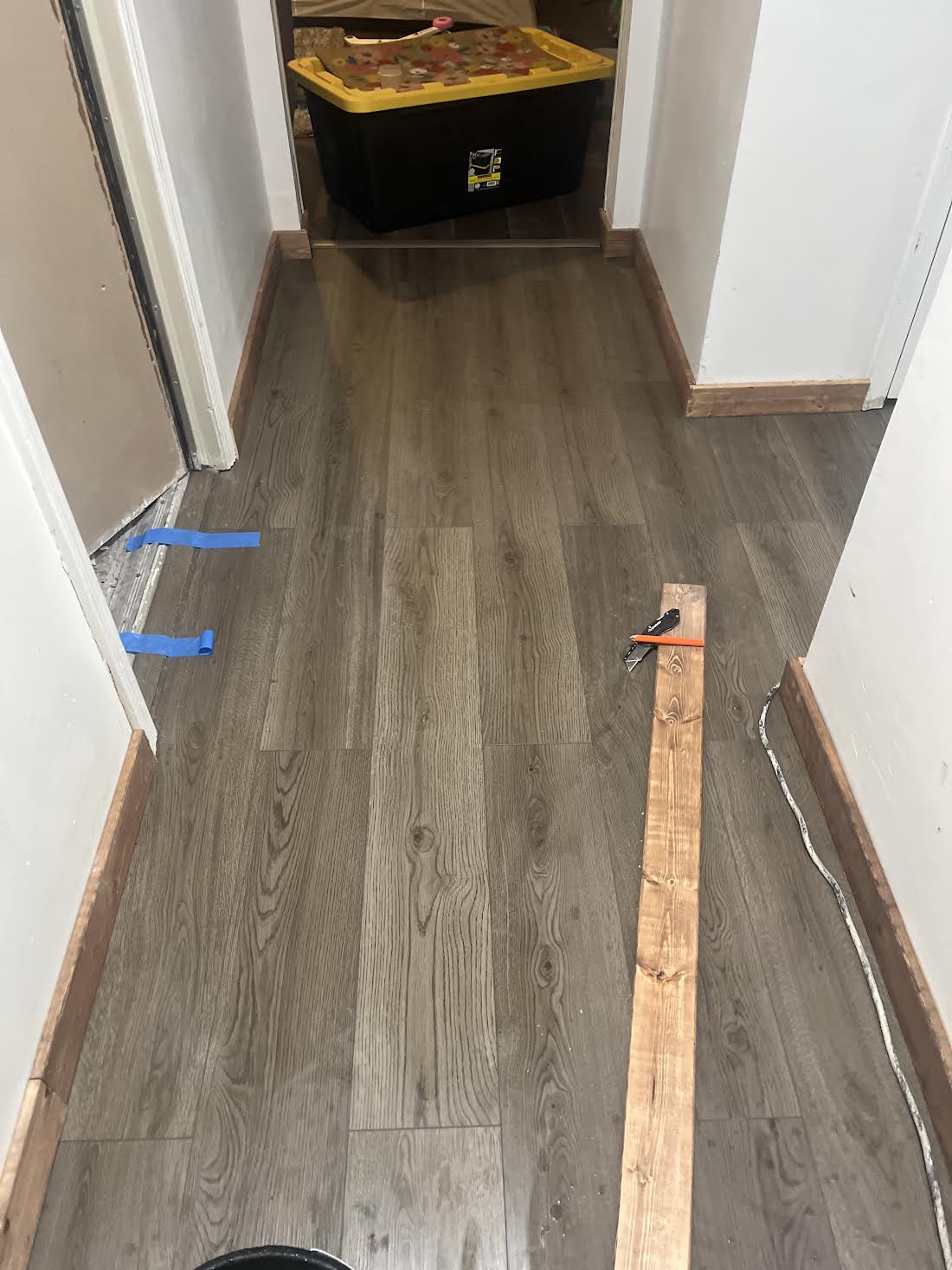 Hallway after installation of dark wood-look luxury vinyl plank flooring